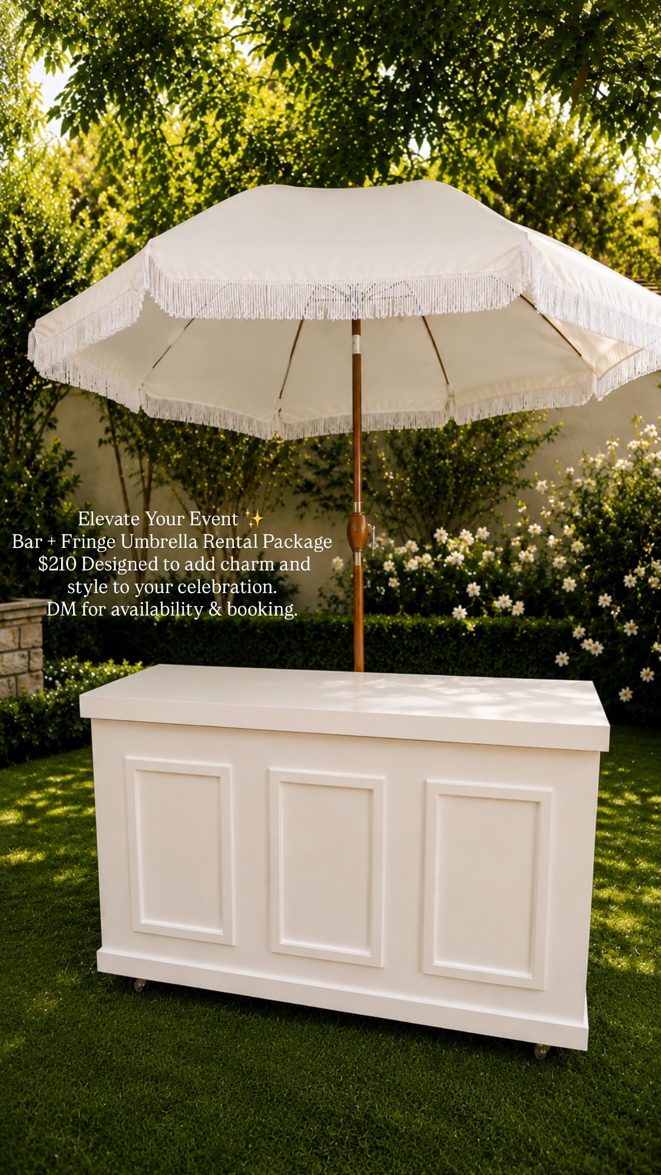 White bar under a cream fringe umbrella in a garden