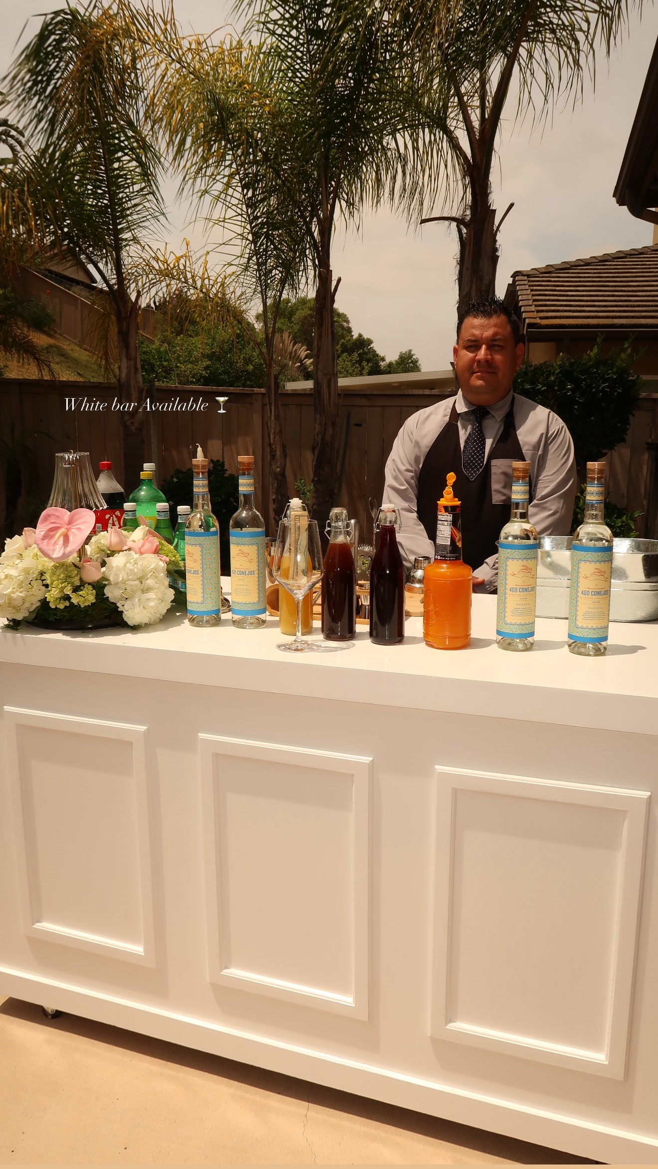 White bar set up for cocktail service at an outdoor event